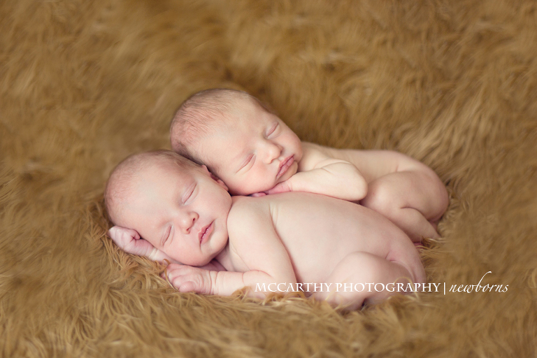 newborn boy twins hugging