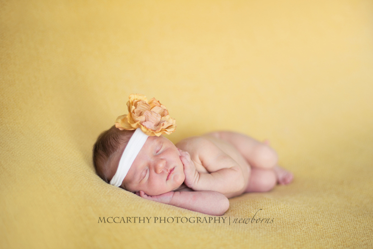 sweet 10 day old baby on a yellow blanket in London ontario